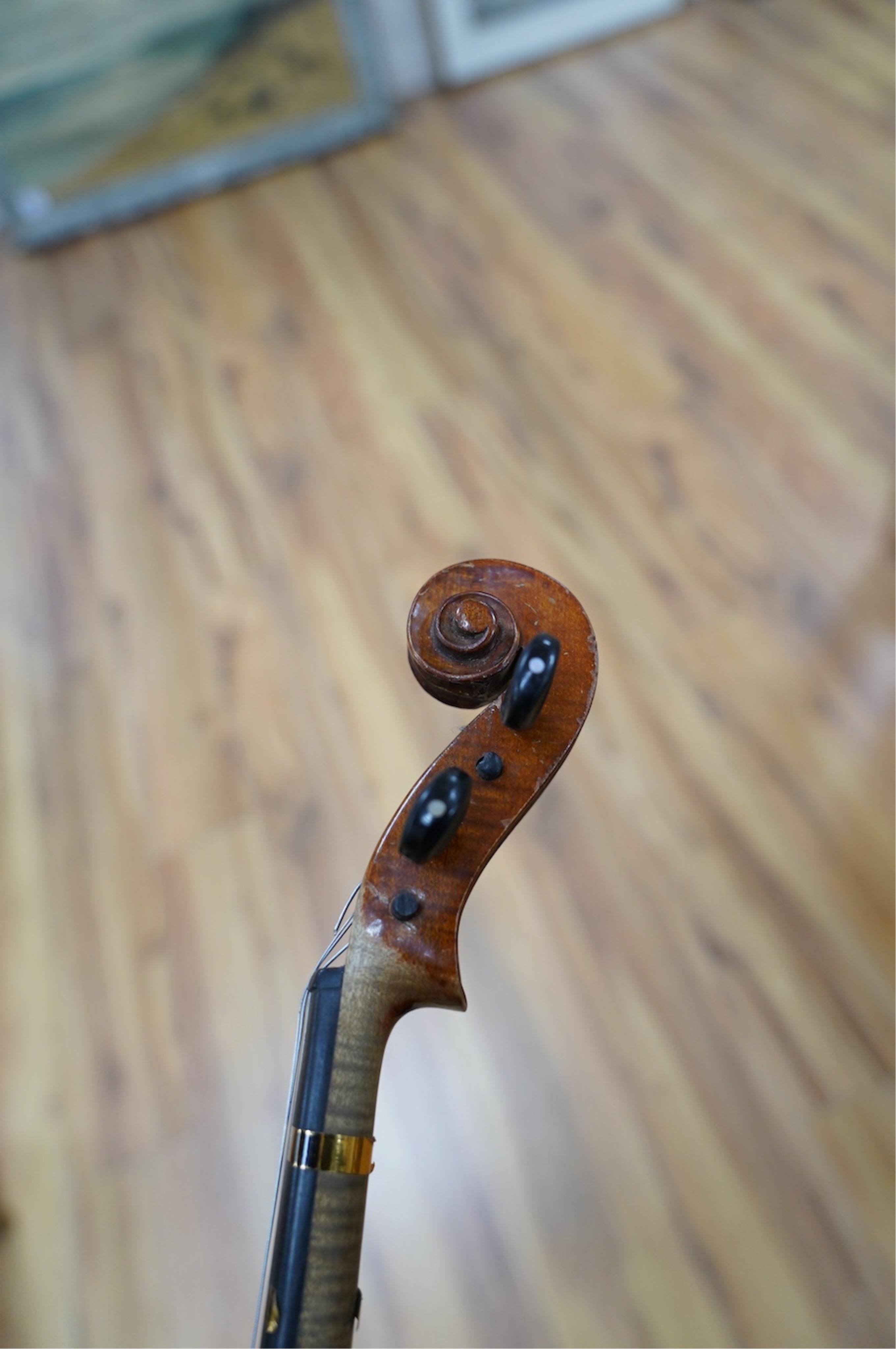 Two late 19th or early 20th century violins, one with case, back of largest measures 36cm. Condition - poor to fair